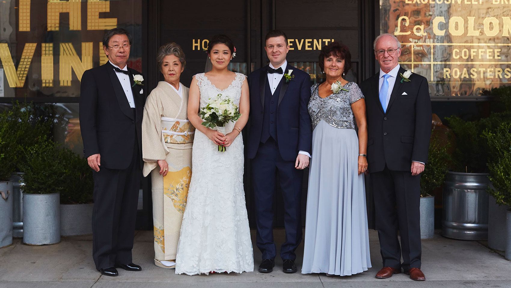 Yoko and Roman with family members in front of Kimpton Hotel Eventi front entrance